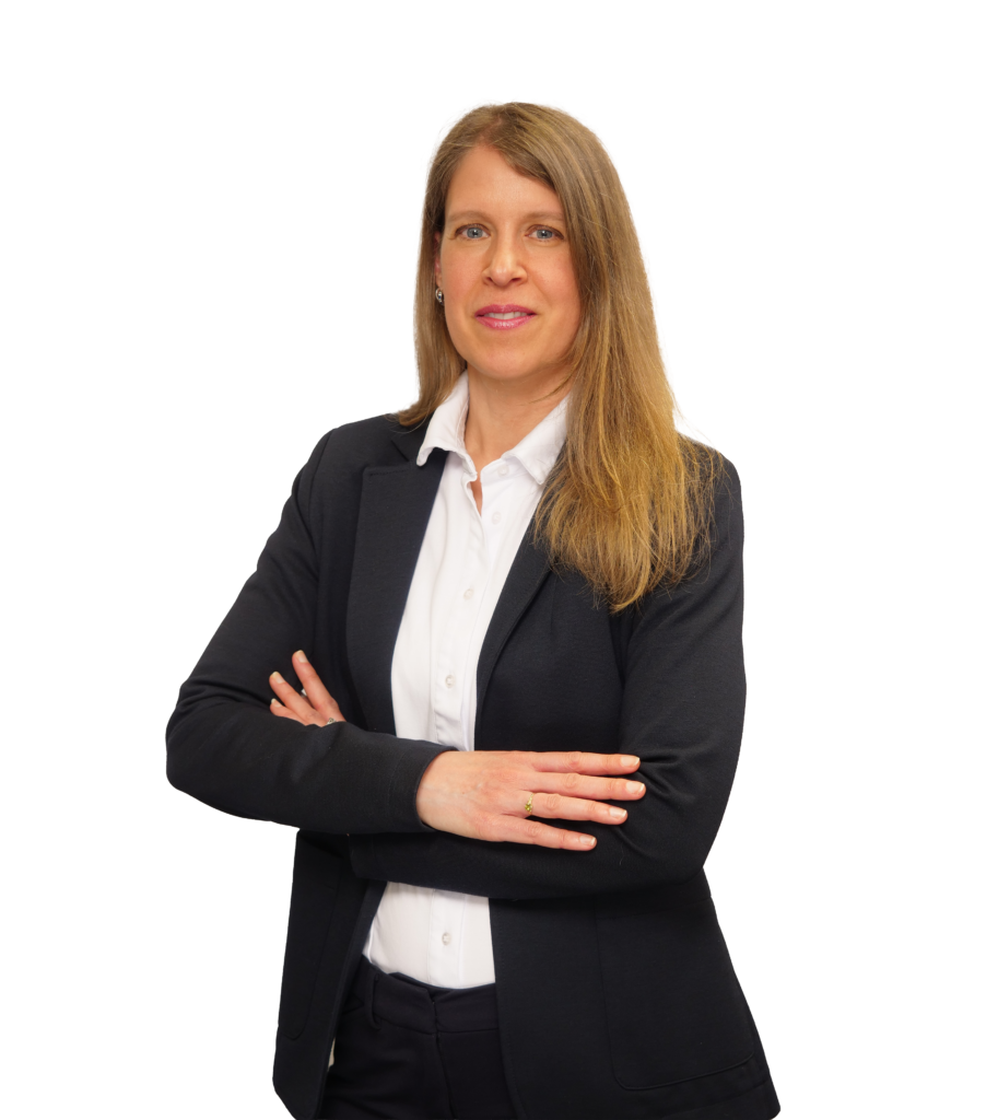 Professional woman with long brown hair in a navy blazer and white shirt, arms crossed against a dark background.